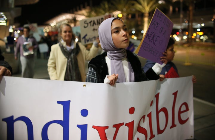 A young muslim Protester, who did not want to be named, marches during a rally against the travel ban at San Diego Airport this week