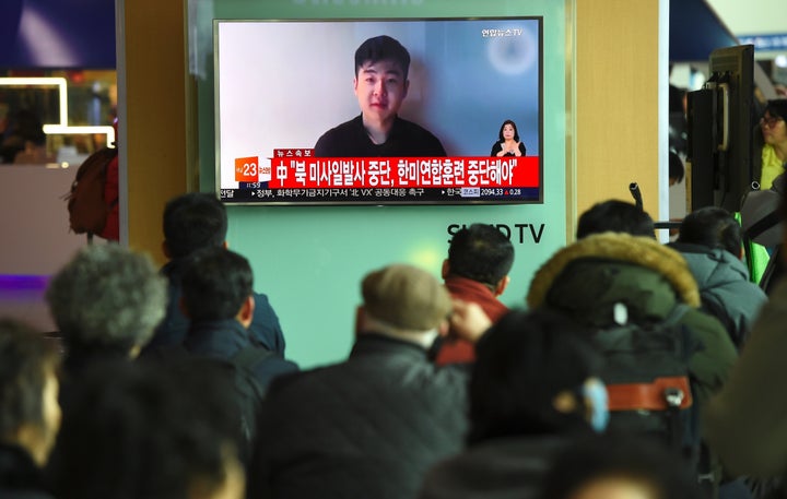 South Koreans watch a video on the news Wednesday that shows a man claiming to be the son of Kim Jong Un's elder half-br