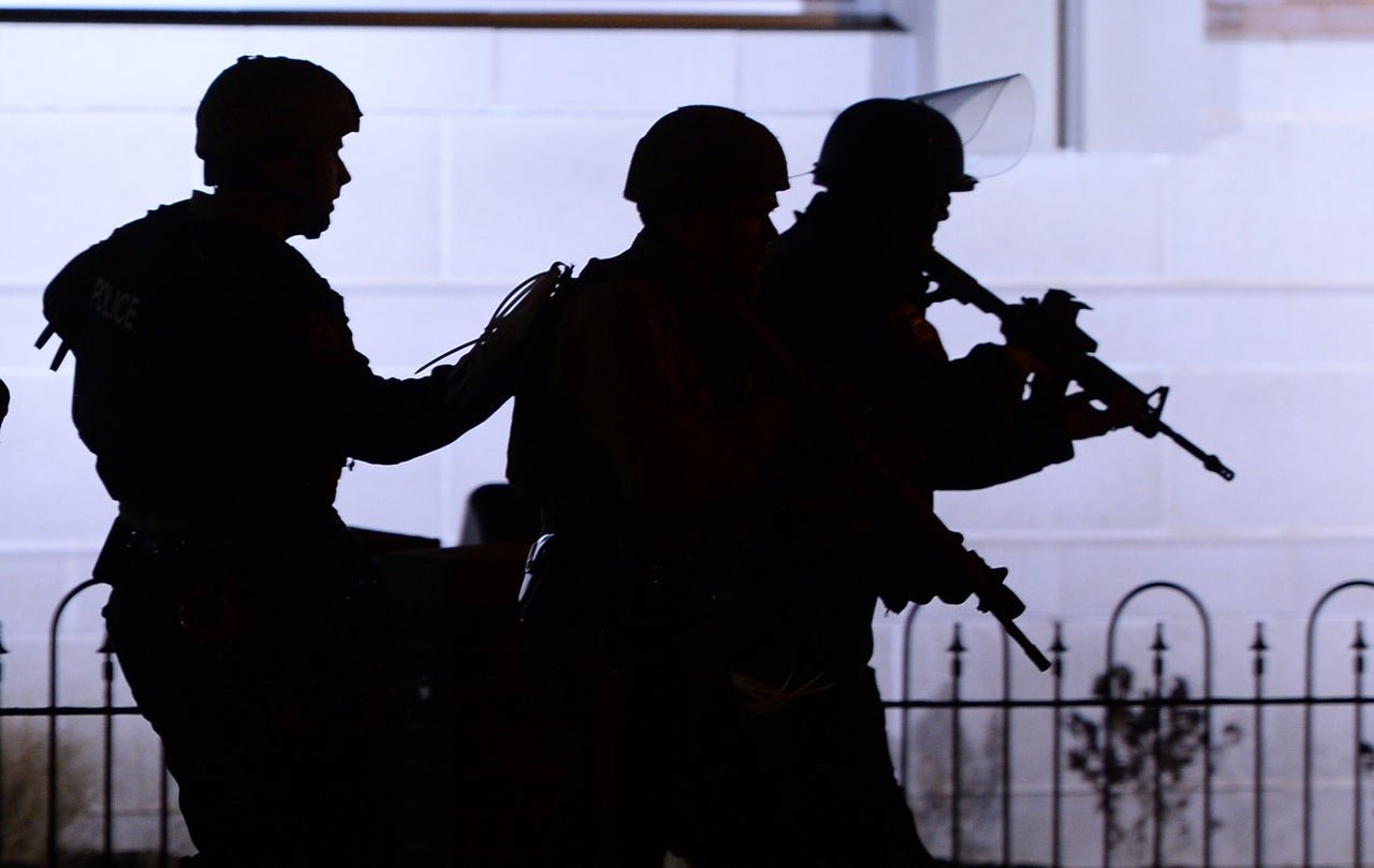 Police take position on Nov. 24, 2014, during clashes with protesters after a grand jury declined to indict a white police officer in the shooting death of 18-year-old Michael Brown in Ferguson, Missouri.