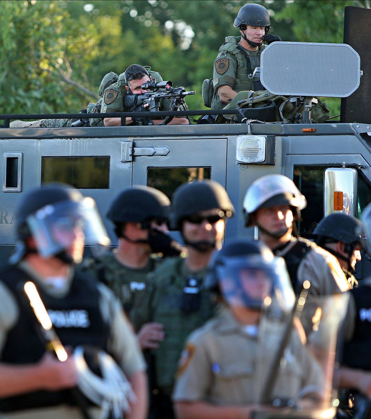 Police officers use military equipment on the streets of Ferguson, Missouri, days after the fatal shooting of Michael Brown.