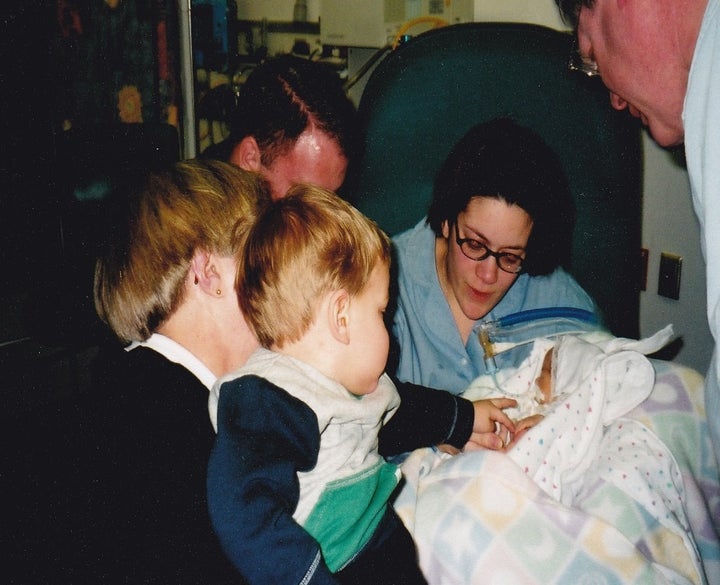 Luke meeting his baby sister, Emma on March 9, 2001.