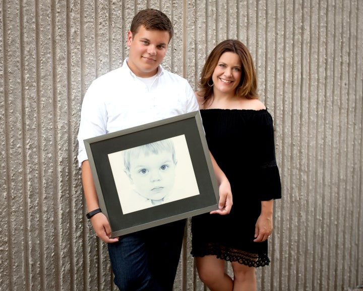 <p><em>Luke, now a high school Senior, holds a photo of himself taken by Susan Johnson of nFocus Photography, just a few weeks after his sister, Emma, passed away. “That photo was a huge part of my healing,” Kate said. “I knew what I had just lost, but that photo of my little boy reminded me what I still had.” </em> </p>