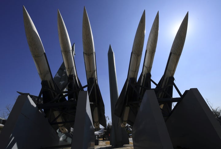Replicas of a North Korean Scud-B missile (C) and South Korean Hawk surface-to-air missiles are displayed at the Korean War M