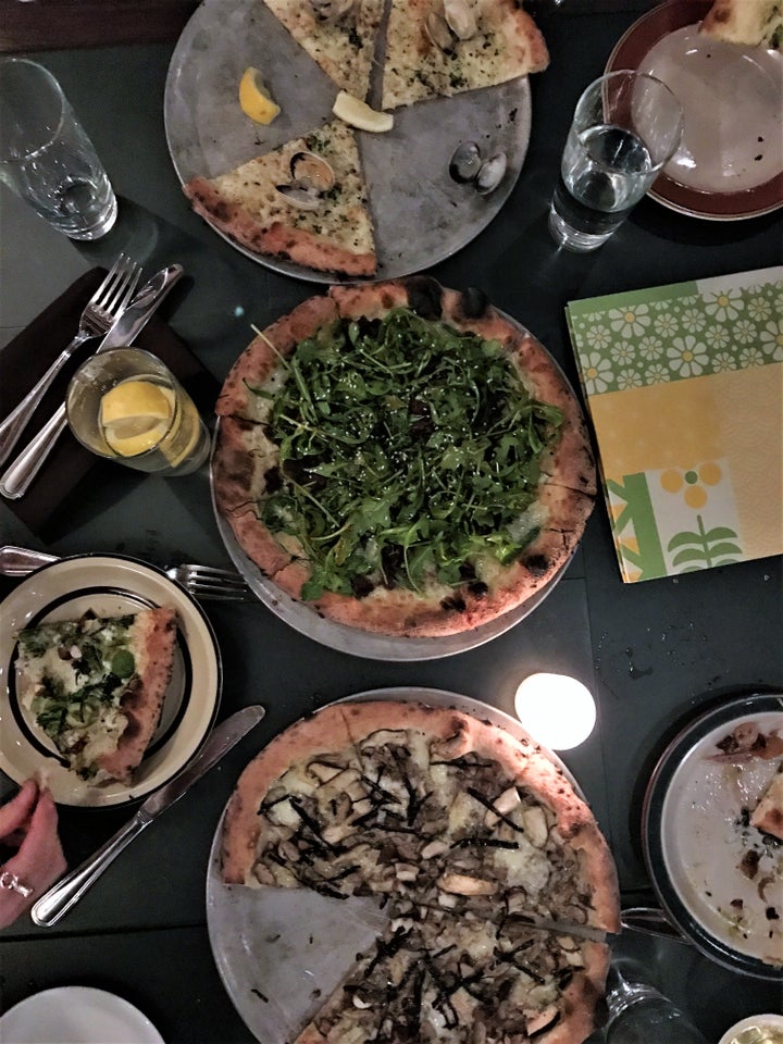 <p>Wood-fired pizzas are a specialty here.</p>