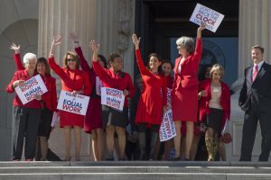 Democratic women House members appear outside the Capitol to support A Day Without A Woman rallies.