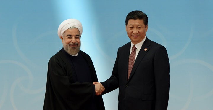 Iran's President Hassan Rouhani (L) shakes hands with his Chinese counterpart Xi Jinping before the opening ceremony of the fourth Conference on Interaction and Confidence Building Measures in Asia (CICA) summit in Shanghai May 21, 2014.