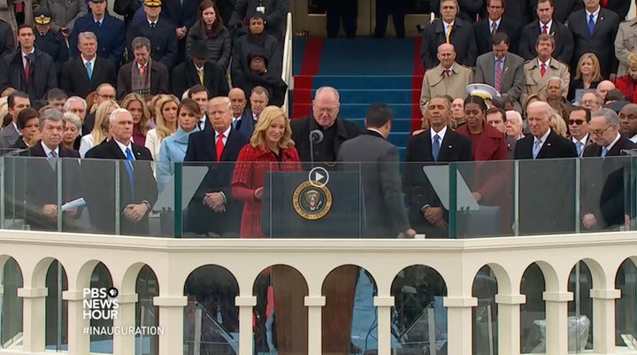 <p>Paula White (center, in red) approaches the podium to deliver prayers at Trump’s inauguration on Jan. 20, 2017.</p>