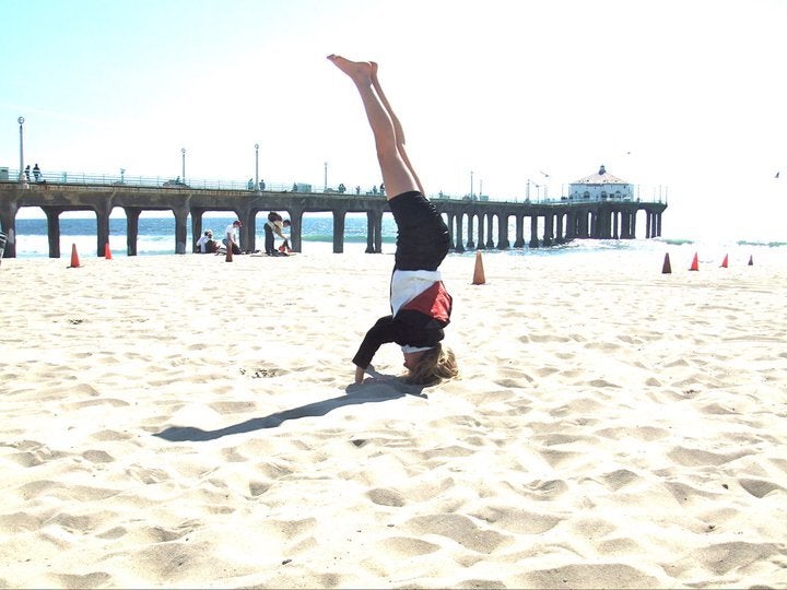 <em>My crooked headstand on Manhattan Beach. </em>