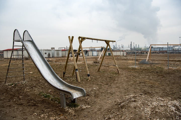 Where has all the fun gone? A playground in the refinery breezes, sans refugee children who were huddled inside. 