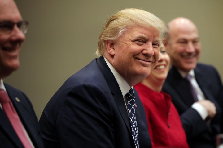 President Donald Trump attends a listening session with CEOs of small and community banks at the White House on Thursday. He ignored shouted questions from the media, as he has all week.