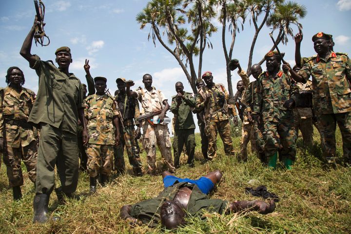 South Sudanese soldiers celebrate over the corpse of a rebel fighter. Government troops are accused of abuses that may constitute war crimes.