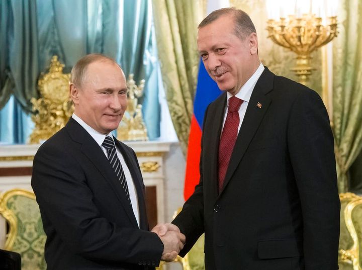 Russian President Vladimir Putin (L) and Turkish President Recep Tayyip Erdogan shake hands in Moscow on Friday. Photo Credit: The Associated Press