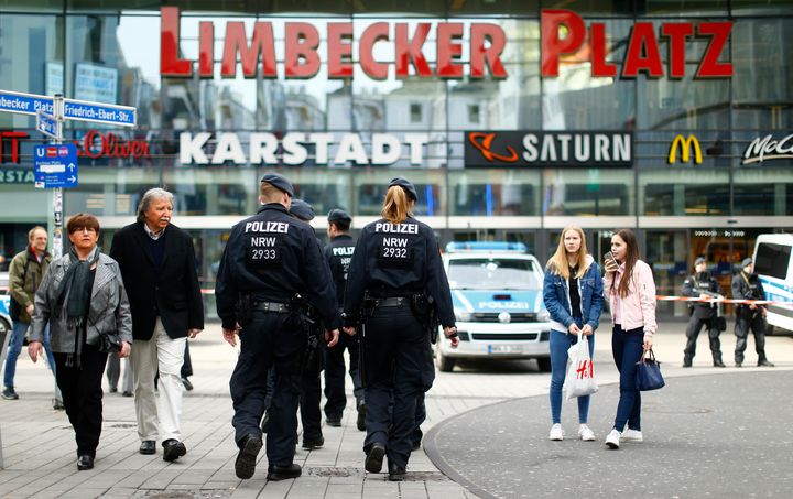 Police walks towards the Limbecker Platz shopping mall in Essen, Germany