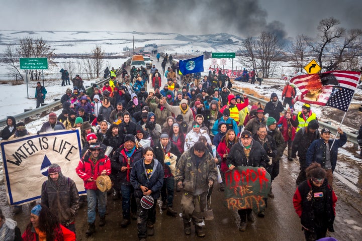 <p>An hour prior to the deadline, a ceremonial exit of Oceti Sakowin. In December, some estimates were well over 10,000 people who were inside the camp.</p>
