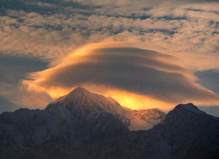 A multi-tiered, brilliant UFO-shaped lenticular cloud over Mt. Tasman, New Zealand.