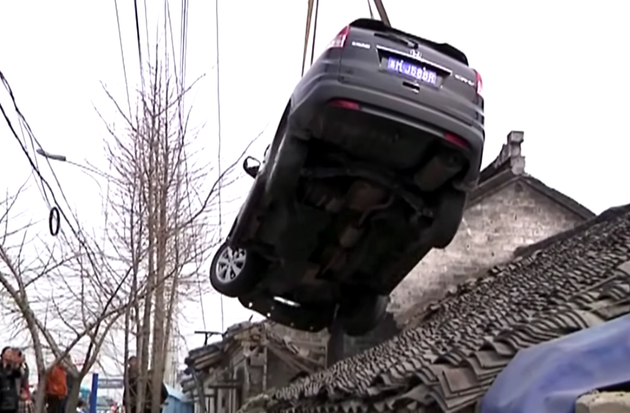 Driver Lands Car On House Roof In Taizhou China After Swerving