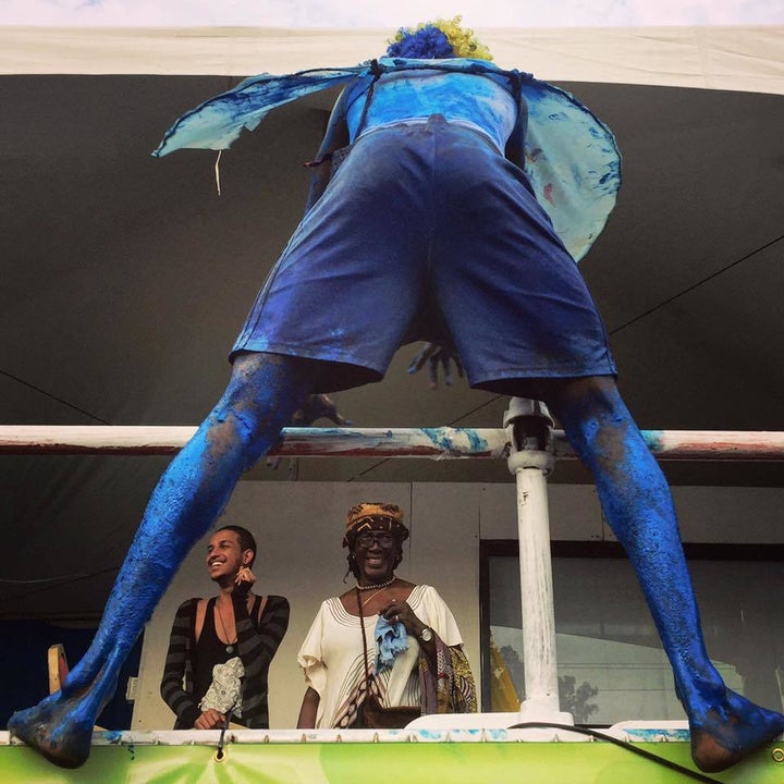 <p>A blue devil jumps into the Canboulay crowd for payment. Only when he receives his money does he move on to his next target</p>