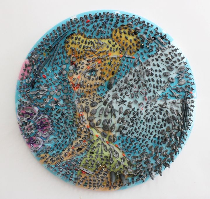 Margaret Roleke, Tink’s Army, plastic toys on fabric, 30 inches in diameter by 3 inches deep