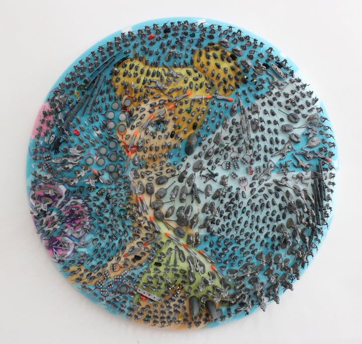 Margaret Roleke, <em>Tink’s Army, </em>plastic toys on fabric, 30 inches in diameter by 3 inches deep