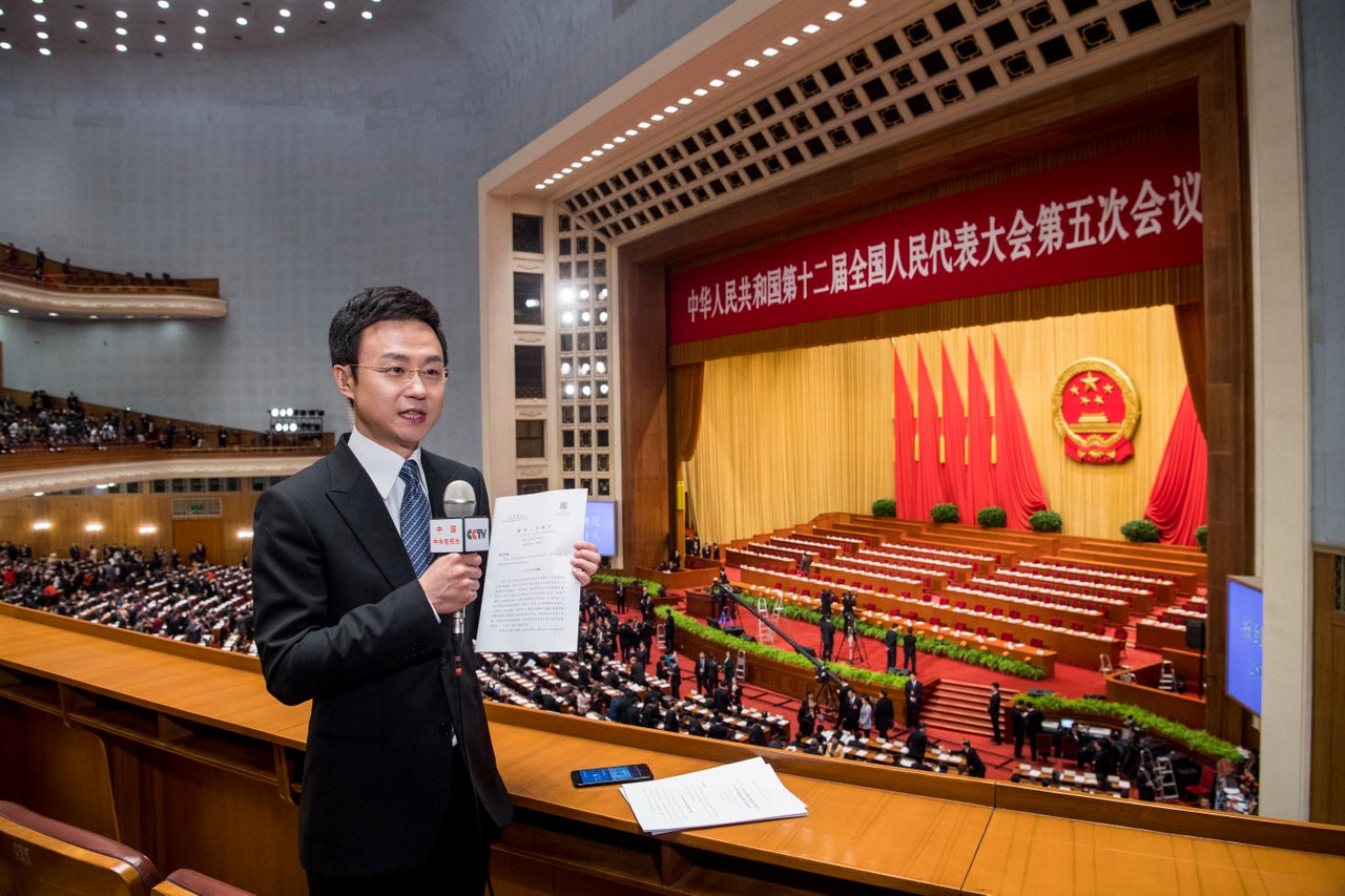 A journalist reports during the opening ceremony of the NPC on March 5, 2017 in Beijing.