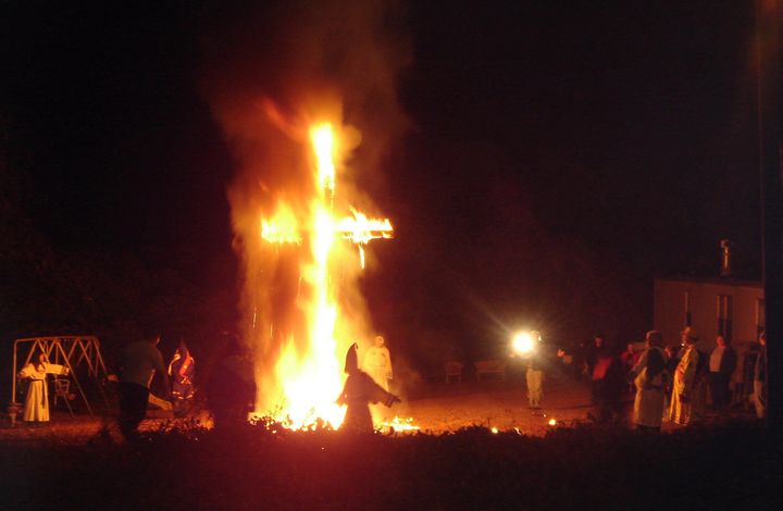 Ku Klux Klansmen and women at a cross lighting in on November 12th, 2005.
