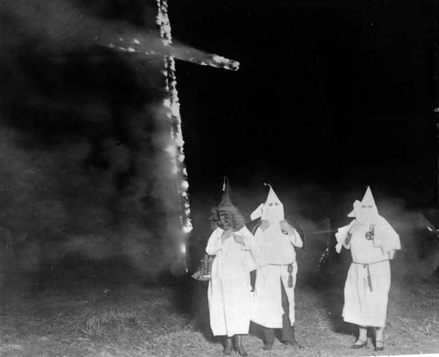 The Ku Klux Klan burning a cross in 1921.