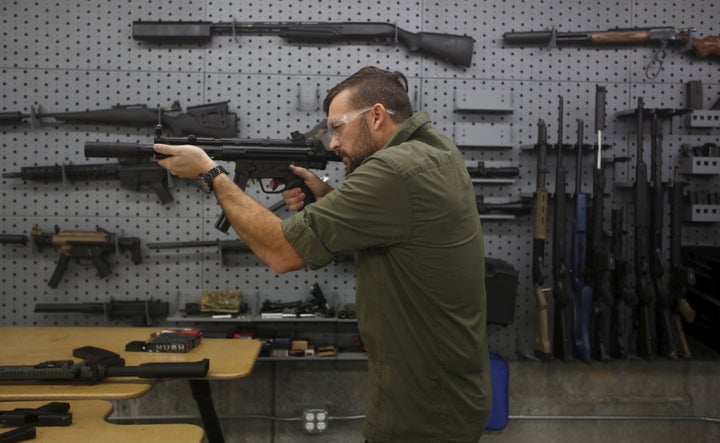 SilencerCo CEO Joshua Waldron fires a rifle with a suppressor in West Valley City, Utah, on Feb. 23, 2016.