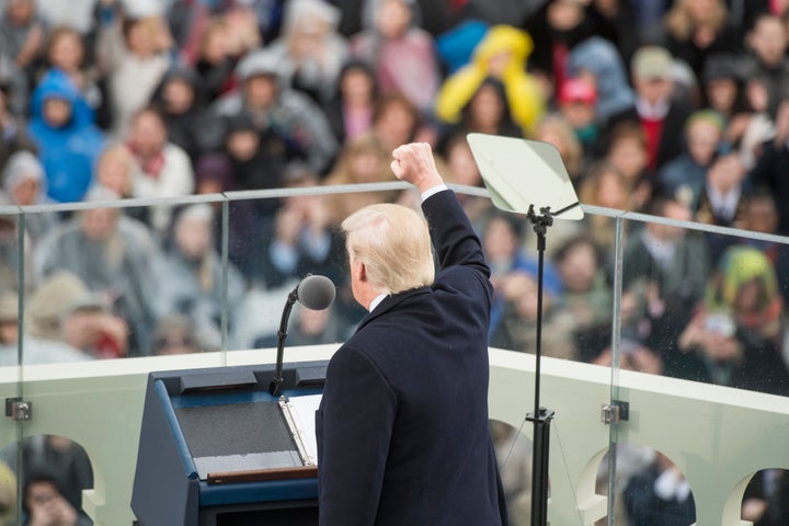 Donald Trump is inaugurated the day after three of his former aides are reported to be targets of an investigation into Russian ties.