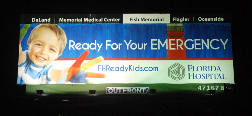 <em>Before: billboard lit by higher-wattage metal halide fixtures</em>
