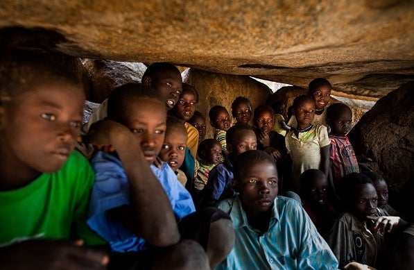 <p>Nuba children hide in a cave to avoid warplanes dropping bombs outside.</p>