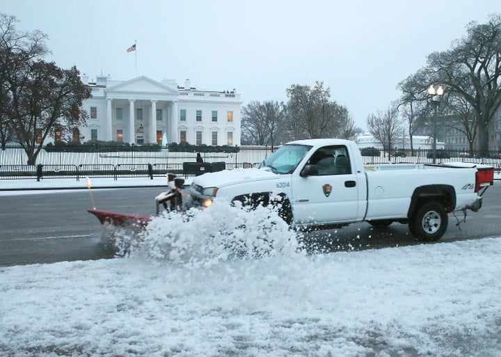 A Park Service snow plow truck pushes snow off Pennsylvania Avenue in front of the White House on March 14, 2017, in Washingt