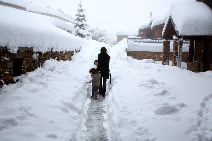 Syrian refugees in the deep snow at a ski chalet in the Greek mountains above Grevena.