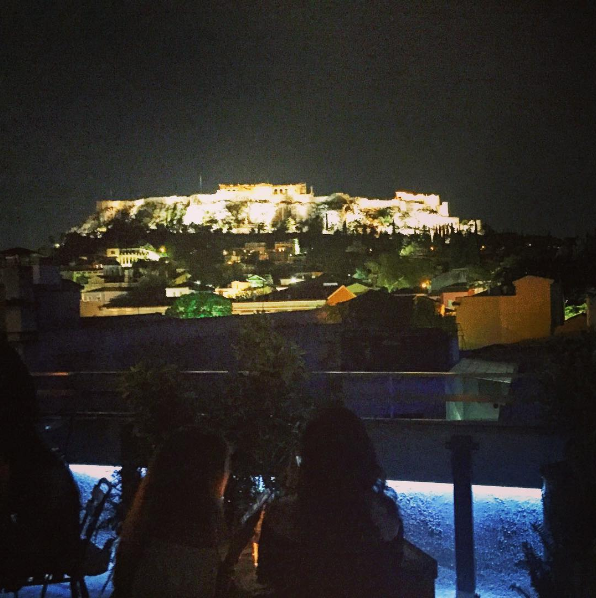 Young girls at a roof garden bar with Acropolis view