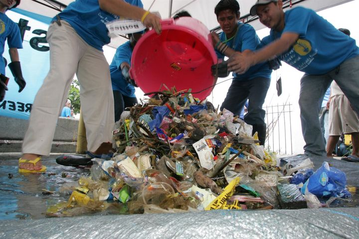 Greenpeace volunteers collect plastic rubbish from Manila Bay. 