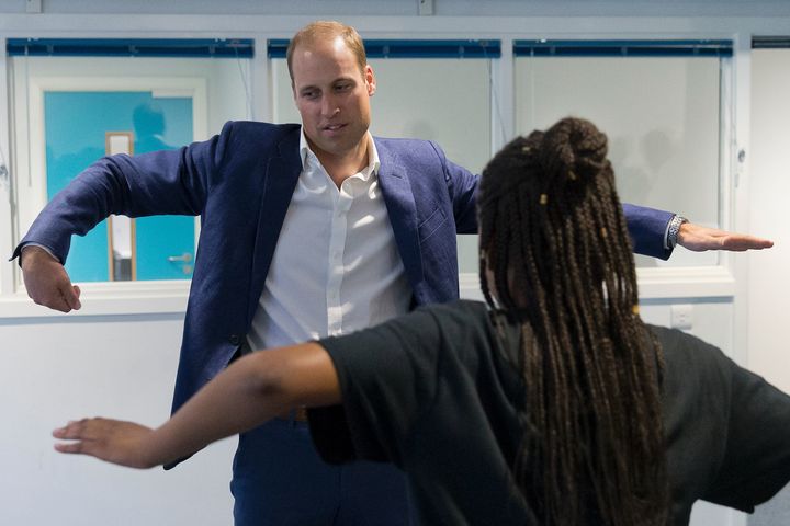 Prince William, Duke of Cambridge, learns a dance move with Scariofunk dance collective during a visit to Caius House Youth Centre in London on September 14, 2016.