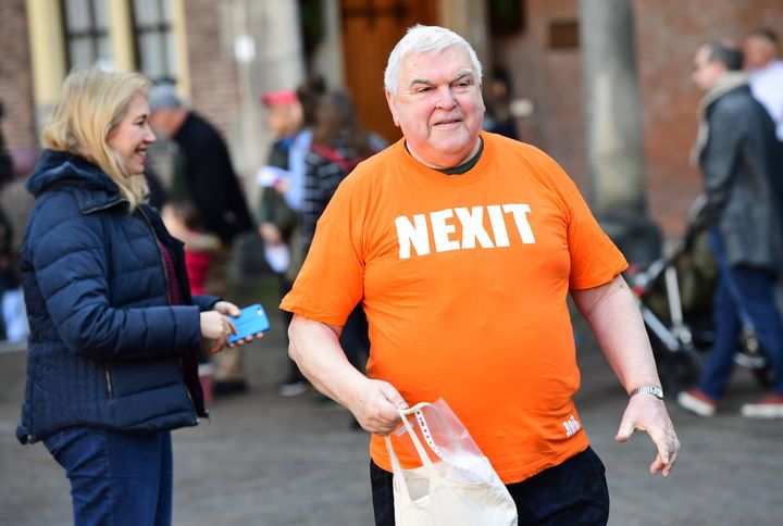 A man wearing a tee-shirt reading 'Nexit' (refering to the so-called 'Nexit' or the Dutch withdrawal from the European Union) walks during the Dutch general elections in The Hague.