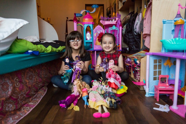 Grace Fetterman (left) and Salma Bokhari play together with dolls.