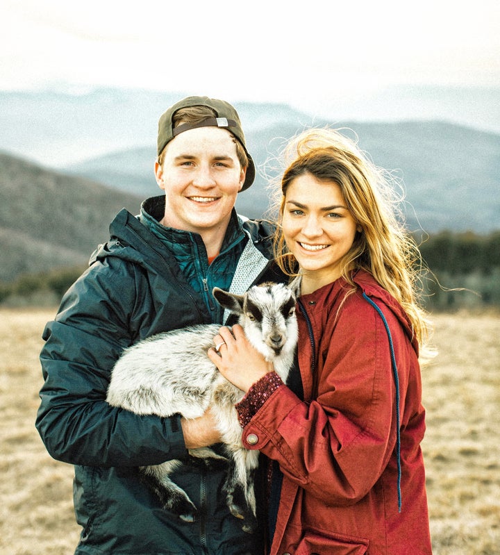 Andrew and Allison with their baby goat Max. 