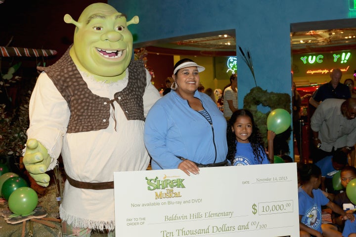 Williams accepted a $10,000 check from DreamWorks Animation and Twentieth Century Fox Home Entertainment for Baldwin Hills Elementary's arts program in 2013. 