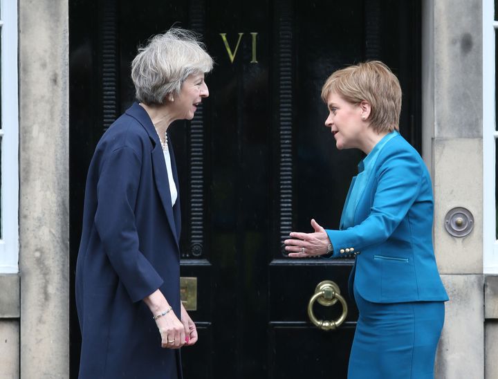 Theresa May (left) is greeted by Scotland's First Minister Nicola Sturgeon at Bute House in Edinburgh.