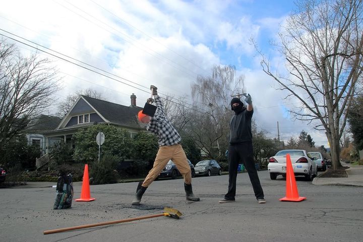 Safety first! Anarchists in Portland make sure to put out orange cones while they fix potholes around the city.