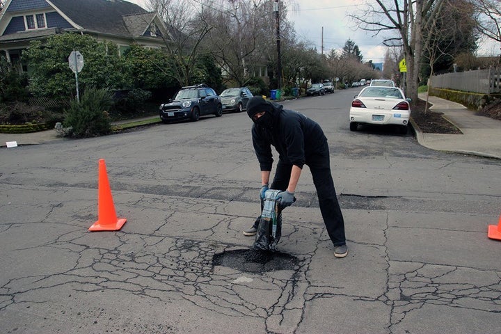 A masked anarchist helps his suburban community in Portland.