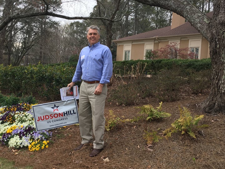 Former Georgia state Sen. Judson Hill (R) poses with a yard sign as he campaigns for the congressional seat vacated by President Donald Trump's secretary of health and human services, Tom Price.