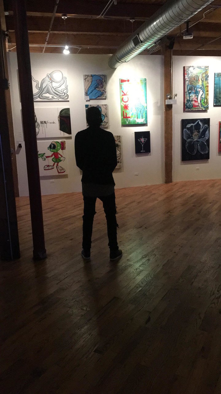 <p> The artist surveys his works. </p>