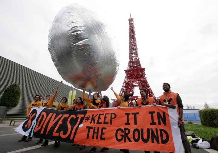 Divestment is now a global movement. Here, protesters in France in December 2015 call for investment funds to move their money out of fossil fuels.