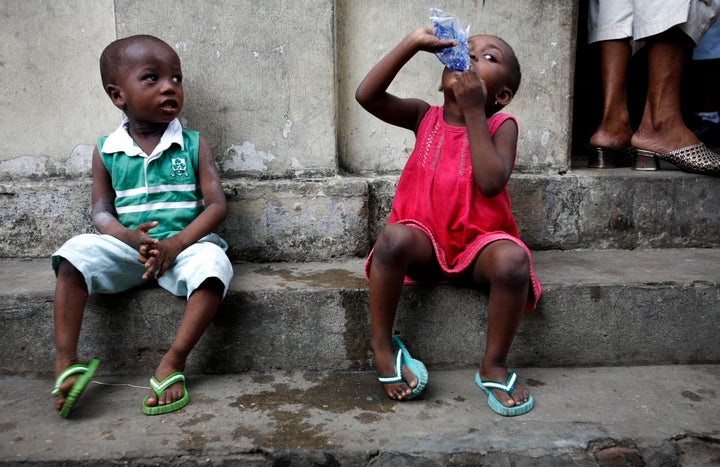 A child drinks water in central Lagos. Around 700,000 children under the age of 5 die every year in Nigeria. Water-related diseases including malaria and diarrhea are a leading cause of death.