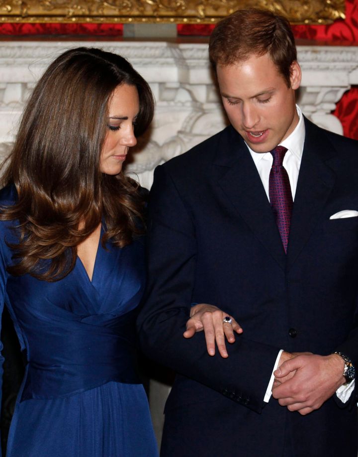 Kate Middleton with future husband, Prince William, wearing a blue sapphire engagement ring, previously belonging to Diana, Princess of Wales as they pose for a photograph in St. James's Palace, London, 16 November 2010.