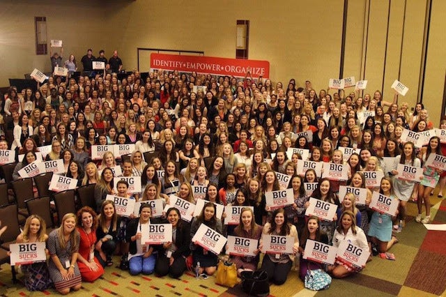 <p>Young women gather behind “Big Government Sucks” in Dallas</p>