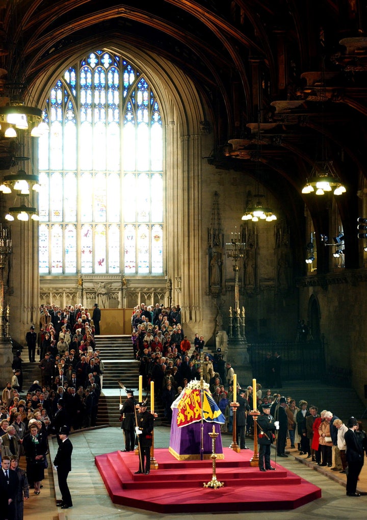 Members of the public file past the coffin of Queen Elizabeth, the Queen Mother as it lies in state in Westminster Hall, April 8, 2002.