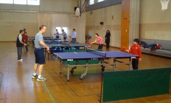 Rumi Khan playing ping pong with Governor Markell in 2010.